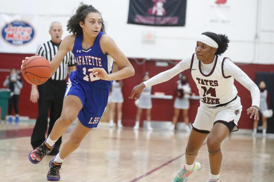 Lafayette’s Savannah Simpson (12) dribbles around Tates Creek’s Jada Bell (14) during a game last season.