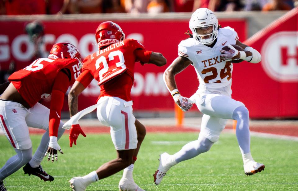 Texas running back Jonathon Brooks looks for room past Houston defensive back Isaiah Hamilton in the first quarter of last week's 31-24 Longhorns win. Through seven games, Brooks has 825 yards on 128 carries.