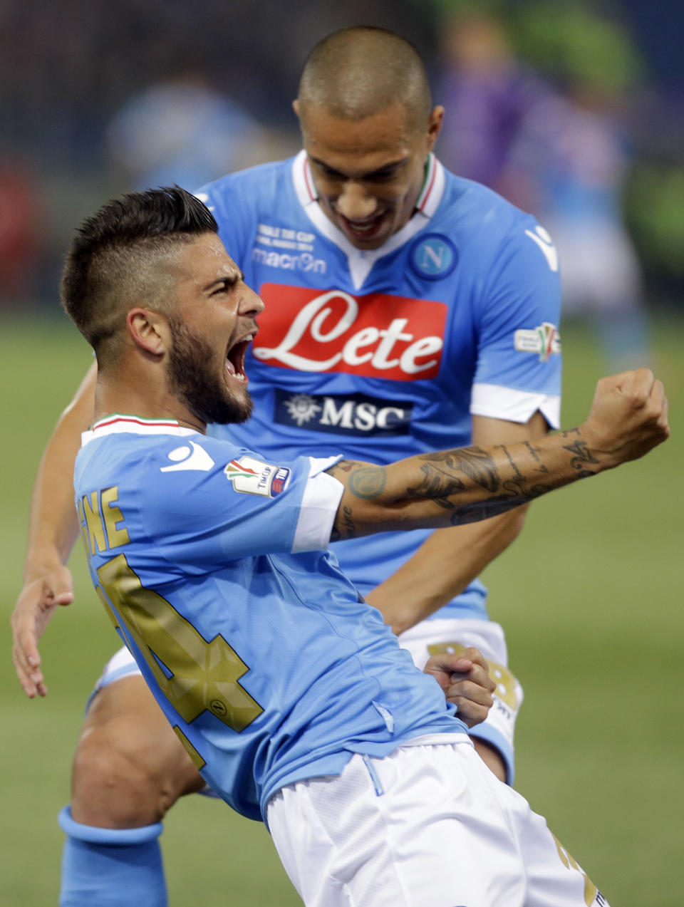 Napoli's Lorenzo Insigne, left, celebrates with teammate Gokhan Inler after he scored during the Italian Cup final match between Fiorentina and Napoli in Rome's Olympic stadium Saturday, May 3, 2014. (AP Photo/Gregorio Borgia)