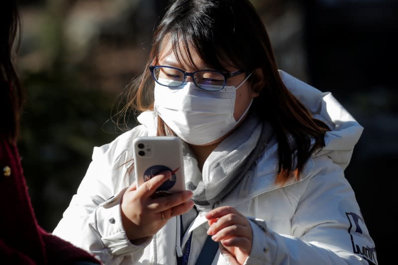 A woman wears a mask in Manhattan's Chinatown district of New York