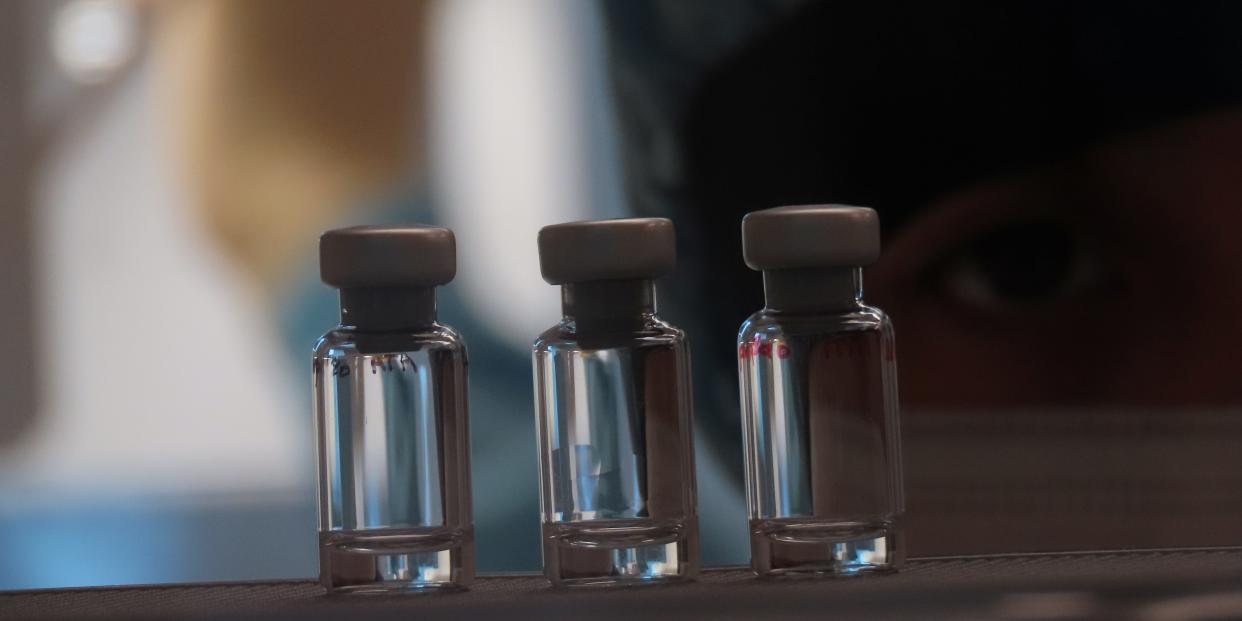 A scientist checks quality control of vaccine vials for correct volume at the Clinical Biomanufacturing Facility (CBF) in Oxford, Britain, April 2, 2020. Picture taken April 2, 2020. Sean Elias/Handout via REUTERS THIS IMAGE HAS BEEN SUPPLIED BY A THIRD PARTY. MANDATORY CREDIT. NO RESALES. NO ARCHIVES