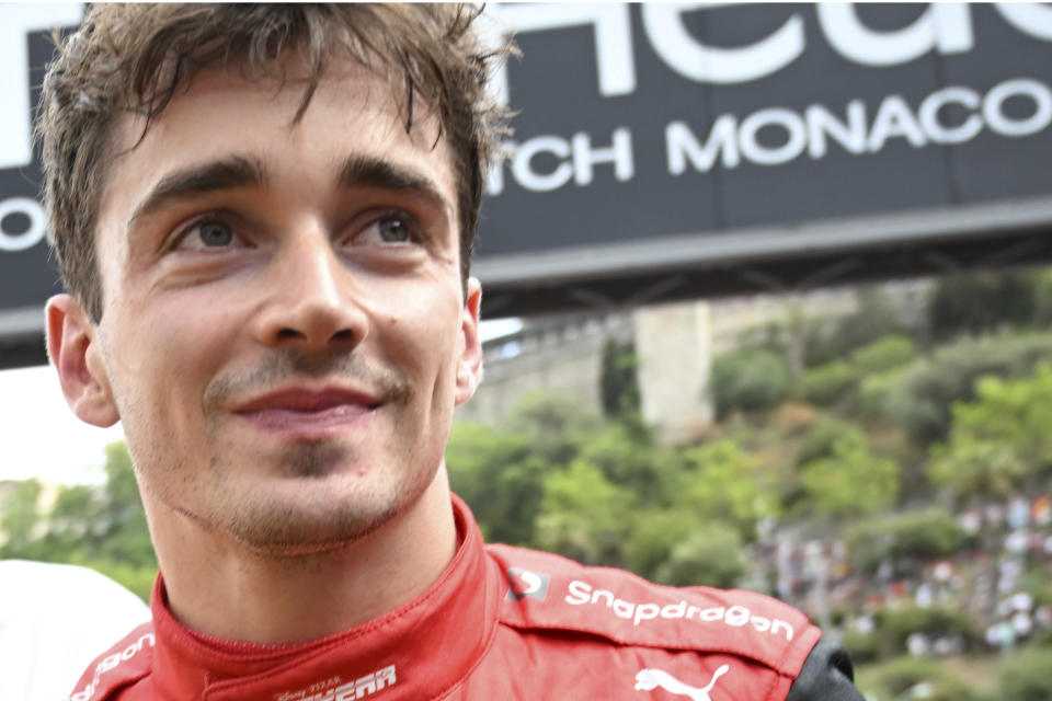 Ferrari driver Charles Leclerc of Monaco smiles after setting the pole position in the qualifying session at the Monaco racetrack, in Monaco, Saturday, May 28, 2022. The Formula one race will be held on Sunday. (Pool Photo/Christian Bruna/Via AP)