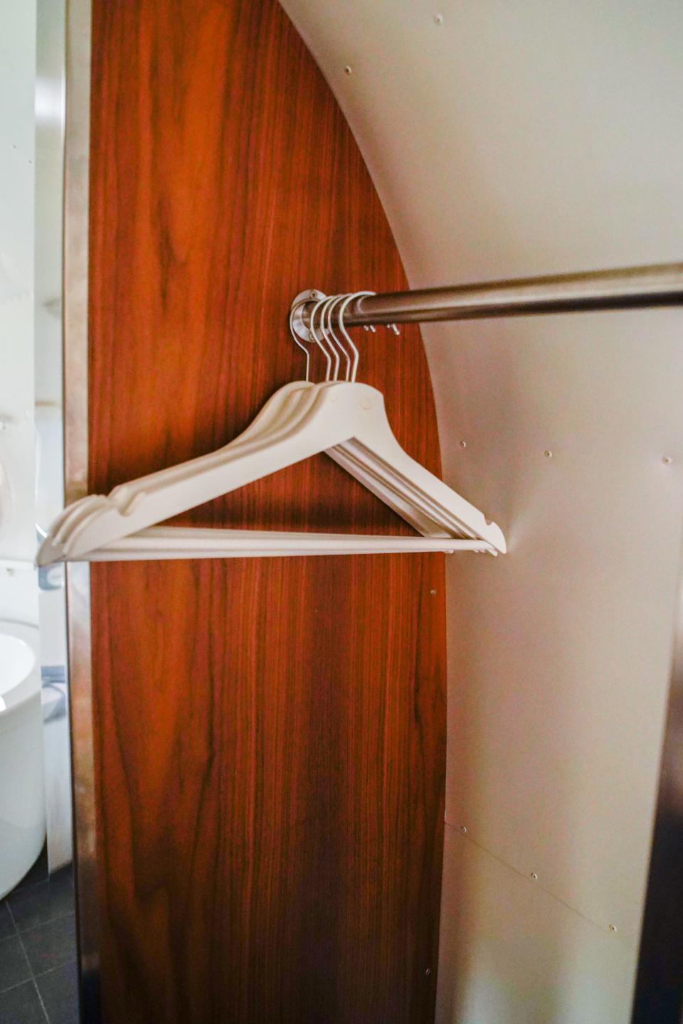 A rack of hangers inside the trailer.