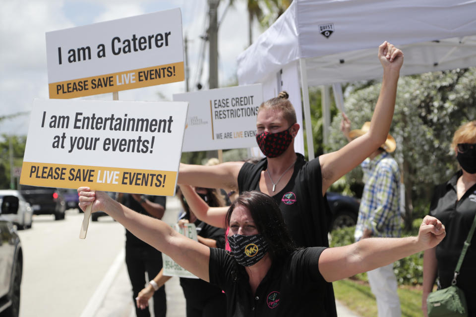 Jennifer Degroff, owner of the Tipsy Rose Bar and Catering Services, protests in support of the live events industry receiving federal aid outside of the office of Sen. Marco Rubio, R-Fla., during the coronavirus pandemic, Thursday, July 30, 2020, in Miami. Many small businesses in the events industry have been shut down since March due to the pandemic. (AP Photo/Lynne Sladky)