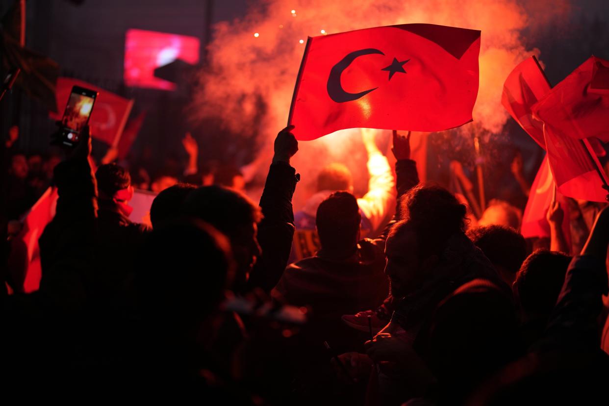 Supporters of the President Recep Tayyip Erdogan celebrate outside AK Party offices in Istanbul, Turkey, Sunday, May 28, 2023. Turkey's incumbent President Recep Tayyip Erdogan has declared victory in his country's runoff election, extending his rule into a third decade. (AP Photo/Khalil Hamra)