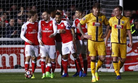 Britain Football Soccer - Sutton United v Arsenal - FA Cup Fifth Round - The Borough Sports Ground - 20/2/17 Arsenal's Theo Walcott celebrates scoring their second goal with Nacho Monreal, Lucas Perez and Gabriel Paulista as Sutton United's Jamie Collins looks dejected Reuters / Eddie Keogh Livepic