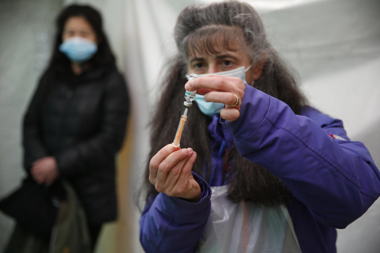 LONDON, ENGLAND - FEBRUARY 28: Dr Jacqueline Marshall prepares a dose of AstraZeneca vaccine at a pop up vaccination unit in Kilburn on February 28, 2021 in London, England. The programme aims to encourage covid-19 vaccine uptake by ferrying patients to vaccination appointments, as well as taking supplies from hospitals to pop-up clinics. (Photo by Hollie Adams/Getty Images)