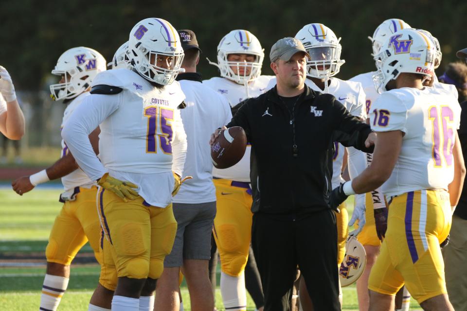 Matt Myers talks to players during Kansas Wesleyan’s 54-0 win over Bethany last year.