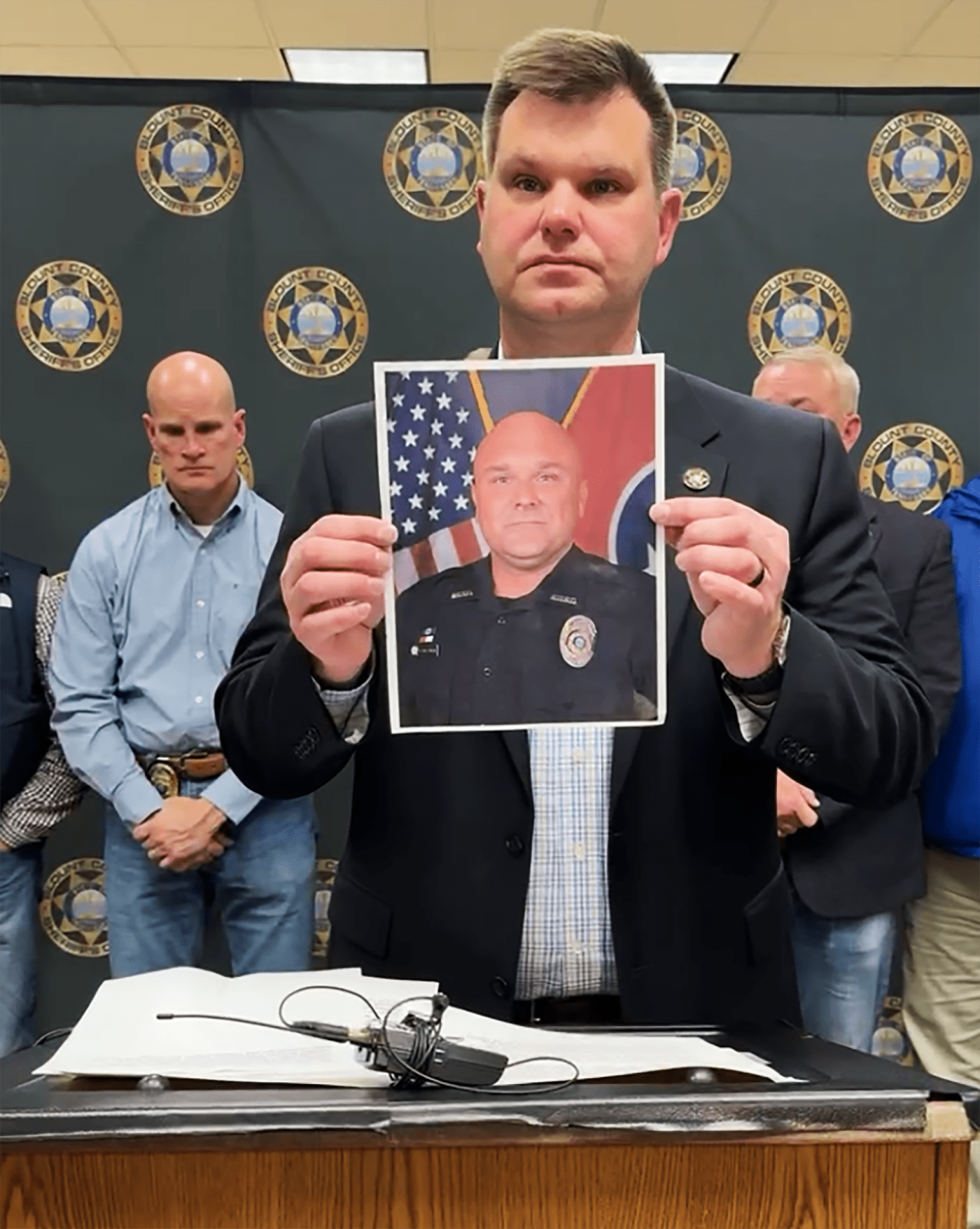 An image of Blount County officer Greg McCowan is raised during a press conference after his death was confirmed by authorities early Friday morning. (Blount County Sheriff's Office)