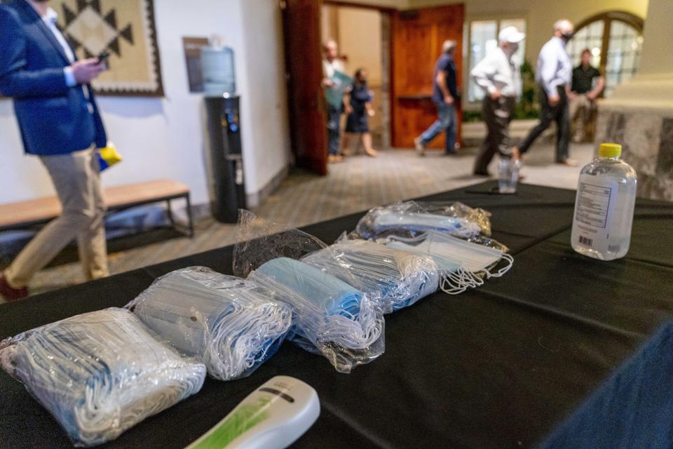 Face masks are left on a table outside a Latinos for Trump Coalition Roundtable where President Donald Trump spoke at Arizona Grand Resort & Spa, Monday, Sept. 14, 2020, in Phoenix. (AP Photo/Andrew Harnik)