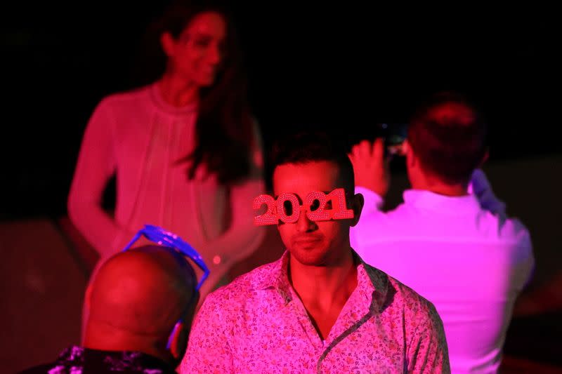 People begin celebrating New Year's Eve at the Sydney Harbour waterfront in Sydney