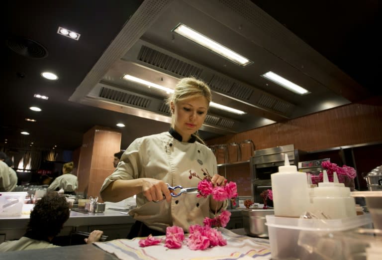 A chef at the Heart restaurant kitchen in Ibiza preparing ornamental flowers on June 29, 2015