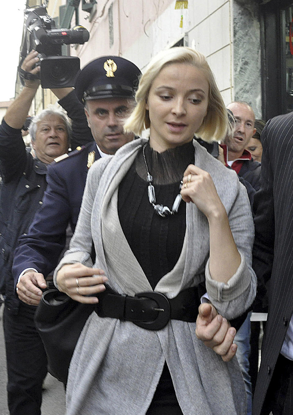 Domnica Cemortan, from Moldavia, leaves the converted Teatro Moderno theater after testifying in a hearing in the trial of Captain Francesco Schettino, in Grosseto, Italy, Tuesday, Oct. 29, 2013. The Moldovan dancer, who was on the bridge when the Costa Concordia crashed into the reef, has testified she was the lover of captain Schettino. The captain of the wrecked Costa Concordia is charged with manslaughter, causing the shipwreck and abandoning ship before the luxury cruise liner's 4,200 passengers and crew could be evacuated on Jan. 13, 2012 when the ship collided with a reef off the Tuscan island of Giglio, killing 32 people. (AP Photo/Giacomo Aprili)