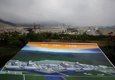 An artist impression of Taishan Nuclear Power Plant, to be operated by China Guangdong Nuclear Power (CGN), is displayed on a viewing platform overlooking the construction site in Taishan, Guangdong province, October 17, 2013. REUTERS/Bobby Yip