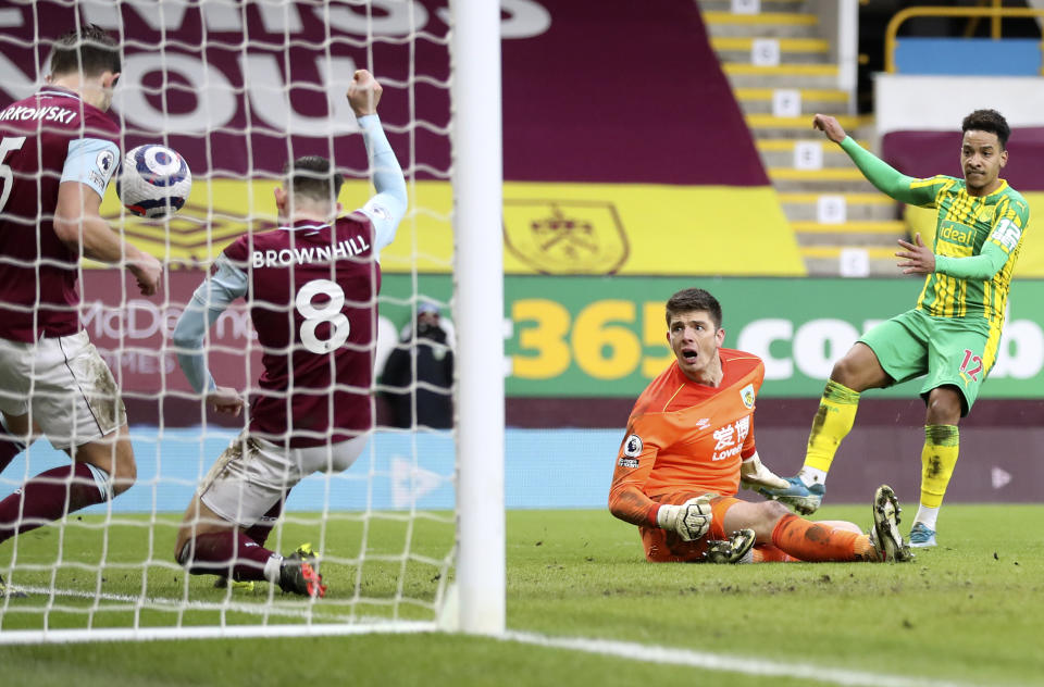 Burnley's goalkeeper Nick Pope, 2nd right, watches as his teammates James Tarkowski, left, and Josh Brownhill, 2nd left, deny West Bromwich Albion's Matheus Pereira, right, from scoring during the English Premier League soccer match between Burnley and West Bromwich Albion at Turf Moor stadium in Burnley, England, Saturday, Feb. 20, 2021. (Martin Rickett/Pool via AP)