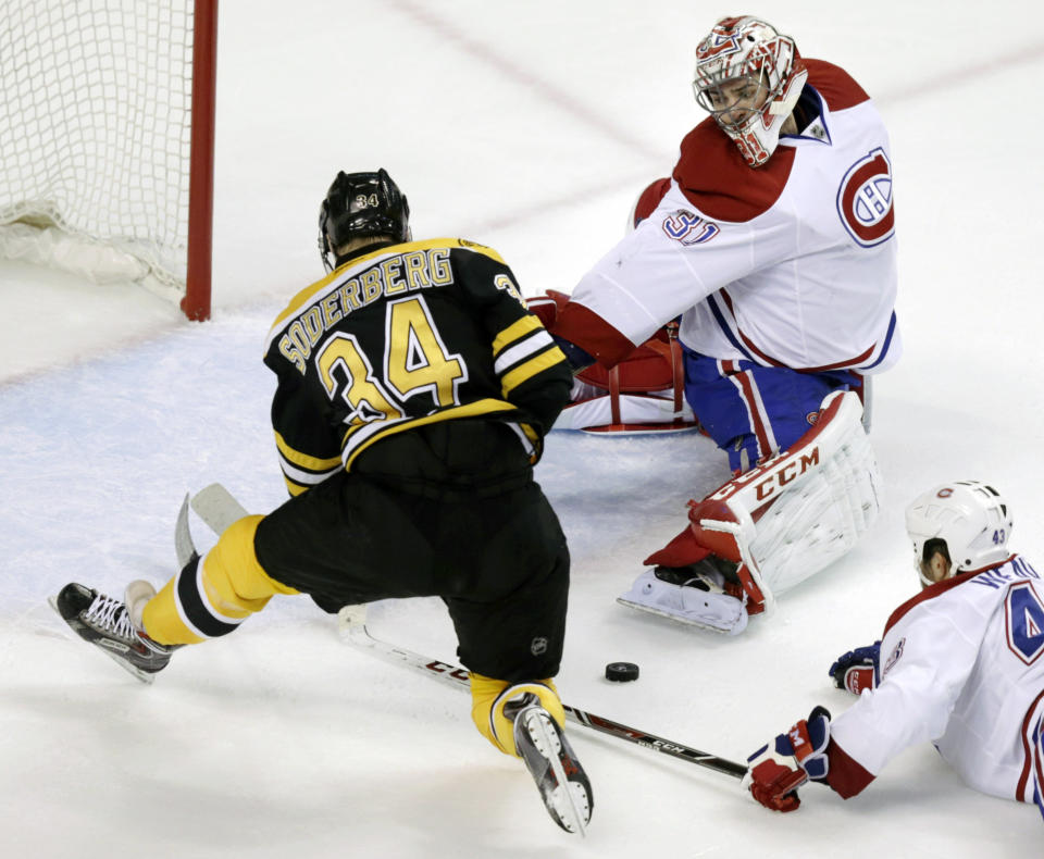 Montreal Canadiens goalie Carey Price (31) reaches back to make a save on a shot by Boston Bruins center Carl Soderberg (34) during the second period of Game 1 in the second-round of a Stanley Cup playoff series in Boston, Thursday, May 1, 2014. (AP Photo/Charles Krupa)