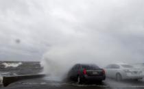 <p>People sit in a car and watch the waves on the shore of Lake Pontchartrain as weather from Tropical Storm Cindy, in the Gulf of Mexico, impacts the region in New Orleans, June 20, 2017. (Photo: Gerald Herbert/AP) </p>