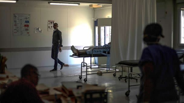 PHOTO: In this Nov. 3, 2022, file photo, medical staff walk past a stretcher with gunshot patient at a clinic run by Doctors Without Borders in the Tabarre neighborhood of Port-au-Prince, Haiti. (Ramon Espinosa/AP, FILE)