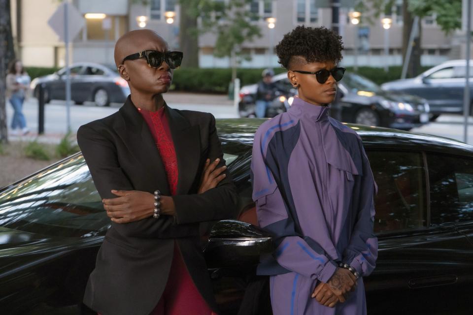 Danai Gurira and Letitia Wright standing by a car