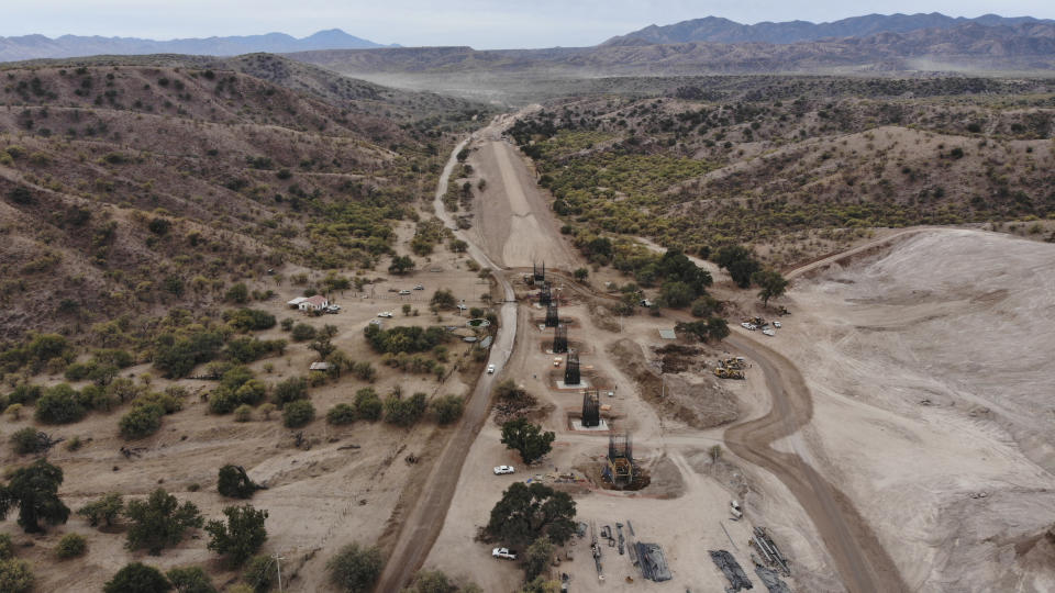 Construction continues for a new train line in northern Mexico, in San Lorenzo, Sonora state, Mexico, Monday, Nov. 13, 2023. Residents in the northern state of Sonora are battling the new train line which they say threatens to displace their homes and cut up the local ecosystem. (AP Photo/Luis Castillo)