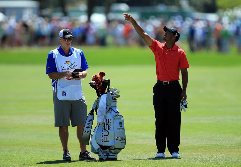 ORLANDO, FL - MARCH 25: Tiger Woods of the USA waits to play his second shot at the par 4, first hole with his caddie Joe LaCava of the USA during the final round of the 2012 Arnold Palmer Invitational presented by MasterCard at Bay Hill Club and Lodge on March 25, 2012 in Orlando, Florida. (Photo by David Cannon/Getty Images)