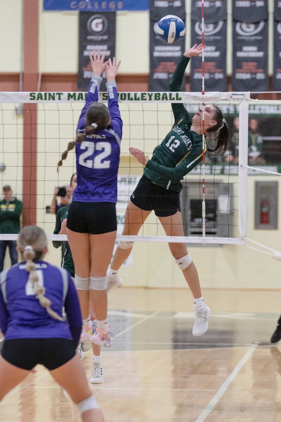 St. Mark's Julia Yurkovich (12) goes for the spike during St. Mark's 3-1 semifinal victory over Delmarva Christian.
