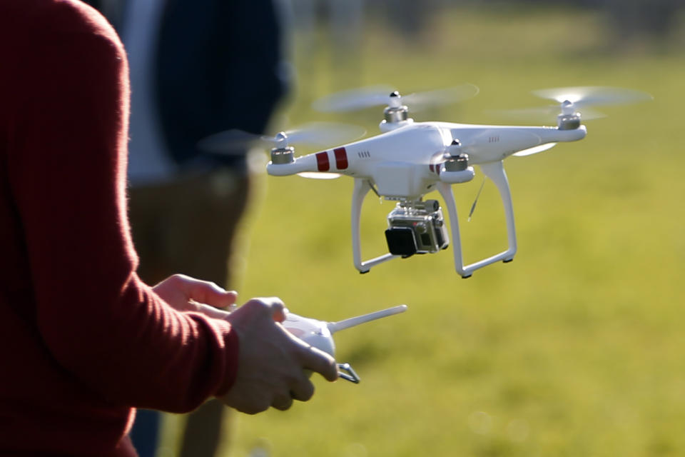 A pilot flies a Phantom drone by DJI company at the 4th Intergalactic Meeting of Phantom's Pilots (MIPP) in an open secure area in the Bois de Boulogne, western Paris, March 16, 2014. Drone operators in France are required to complete a training course to fly an unmanned aerial vehicle and also receive written approval for flights in urban areas. Picture taken March 16, 2014.   REUTERS/Charles Platiau (FRANCE - Tags: SCIENCE TECHNOLOGY)