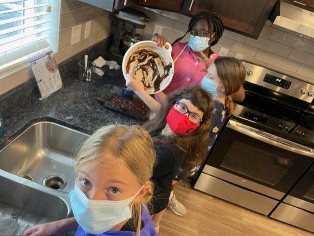 Gilbert Intermediate School fifth graders (from left to right) Paisley Wilberts, 11, Jaida Everett, 11, Zoey Myers, 11, and Gracia Avochinou, 10,  make brownies at a Ronald McDonald House in Des Moines.