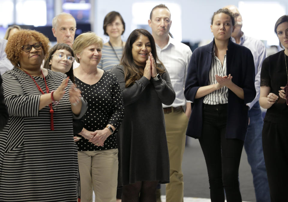 Associated Press staff applaud as the list of Pulitzer Prize winners are announced at AP headquarters in New York, Monday, April 15, 2019. A team of three Associated Press journalists won a Pulitzer Prize in international reporting Monday for their work documenting torture, graft and starvation in Yemen's brutal civil war. (AP Photo/Seth Wenig)