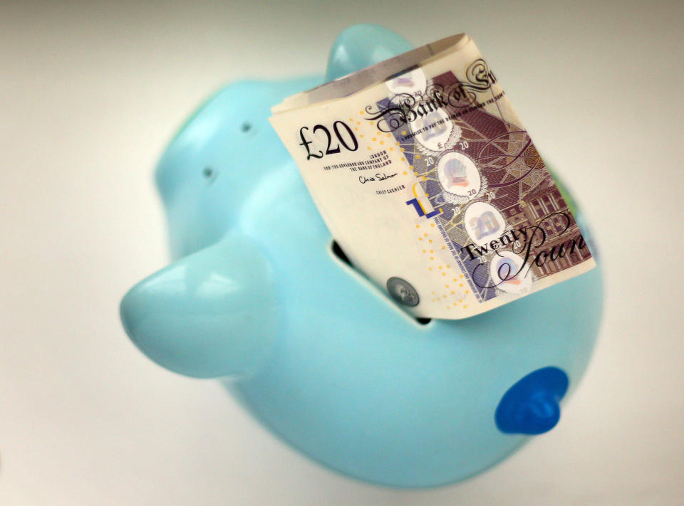 File photo dated 06/01/15 of money in a piggy bank. Around 12 million adults do not have a savings product to fall back on if times get tough, a report has estimated.