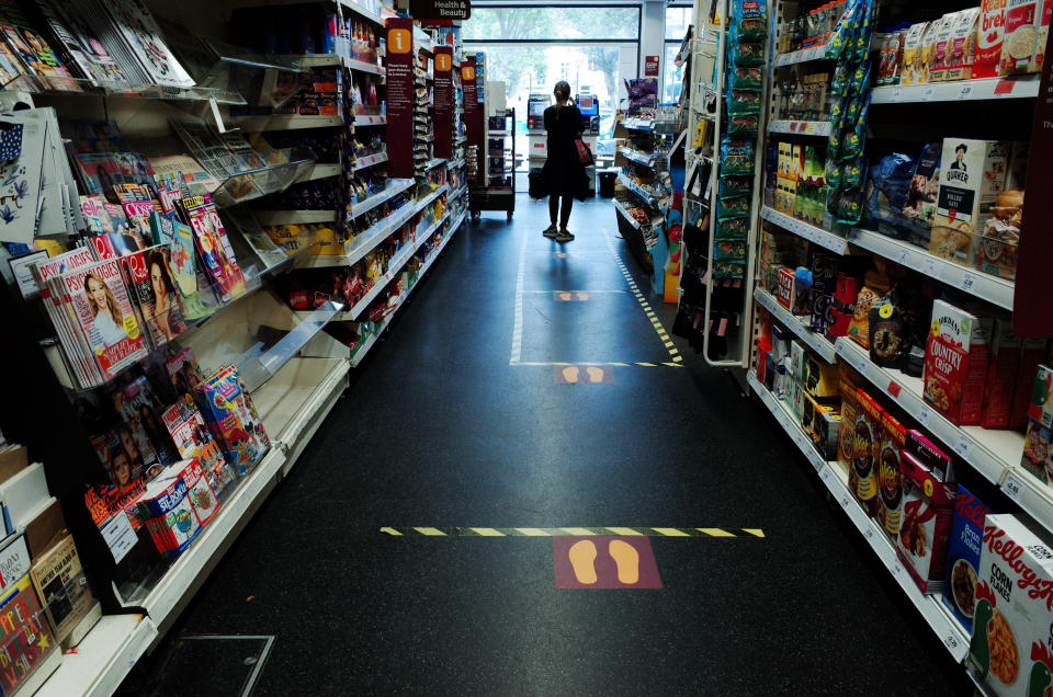 Social distancing markers subdivide the aisle space of a branch of supermarket chain Sainsbury's in the Bayswater district of London, England, on May 13, 2020. Today marked the first day of several eased restrictions across England as a slow loosening of the coronavirus lockdown gets underway, with people now encouraged to return to work if unable to do so from home and unlimited outdoor exercise now allowed. Non-essential shops will not be permitted to reopen before at least June 1, however, and the hospitality sector is to remain closed until at least July 4. With those closure orders still in place, much of central London, which is mostly comprised of retail and hospitality venues, remained largely as deserted today as it has been in recent weeks. (Photo by David Cliff/NurPhoto via Getty Images)