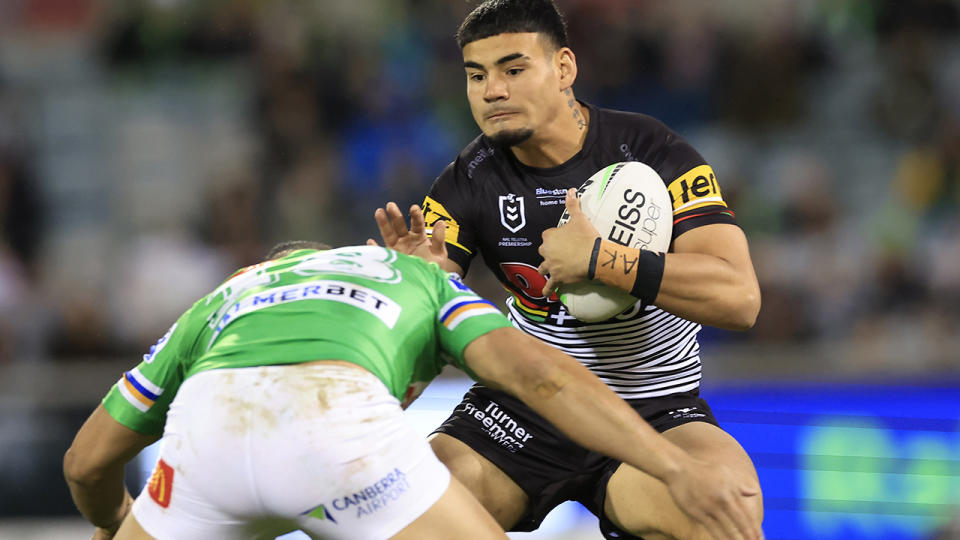 Taylan May runs the ball in an NRL match against the Canberra Raiders.