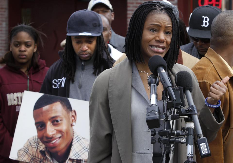 FILE - In this April 21, 2011, file photo, Thulani DeMarsay, right, aunt of Danroy "DJ" Henry Jr., who was shot and killed by a police officer, speaks as Henry's uncle Jamele Dozier, left, holds a photograph of Henry during a news conference in Boston's Roxbury neighborhood. Around the U.S., protesters have been calling for prosecutors to take a second look at police killings of Black people, including Henry. (AP Photo/Steven Senne, File)