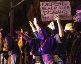 Demonstrators confront Oakland police officers during a protest against police brutality in Oakland, Calif., on Friday, April 16, 2021. (AP Photo/Ethan Swope)