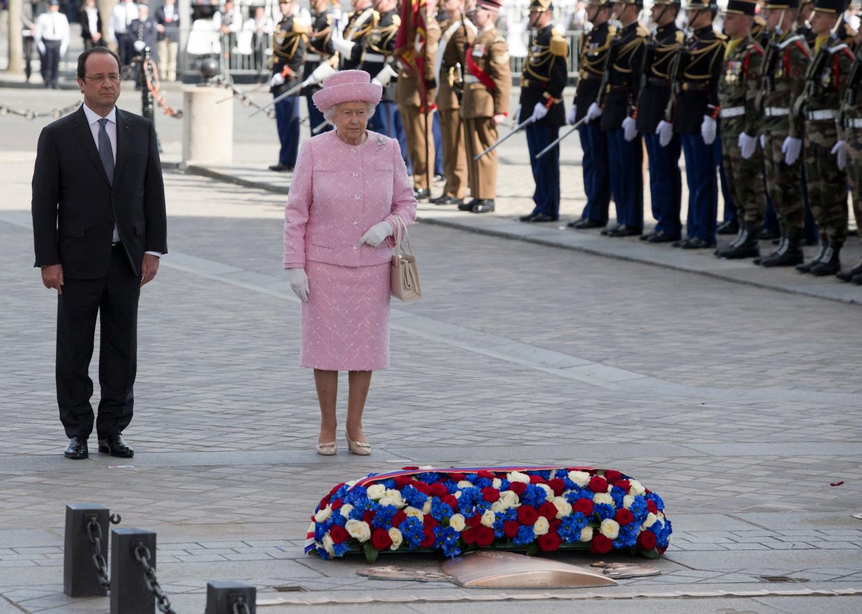 France's President Francois Hollande, left, and Britain's Queen Elizabeth II take part in a ceremony on the Tomb of the Unknown Soldier at the Arc de Triomphe in Paris, France, Thursday, June 5, 2014 (Copyright 2023 The Associated Press. All rights reserved.)