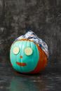 <p>Going for a bit of humor with your Halloween decorations? This silly and easy pumpkin idea is the way to go. Just paint on a "face mask" and print out cucumber images from the internet and tape on.</p>