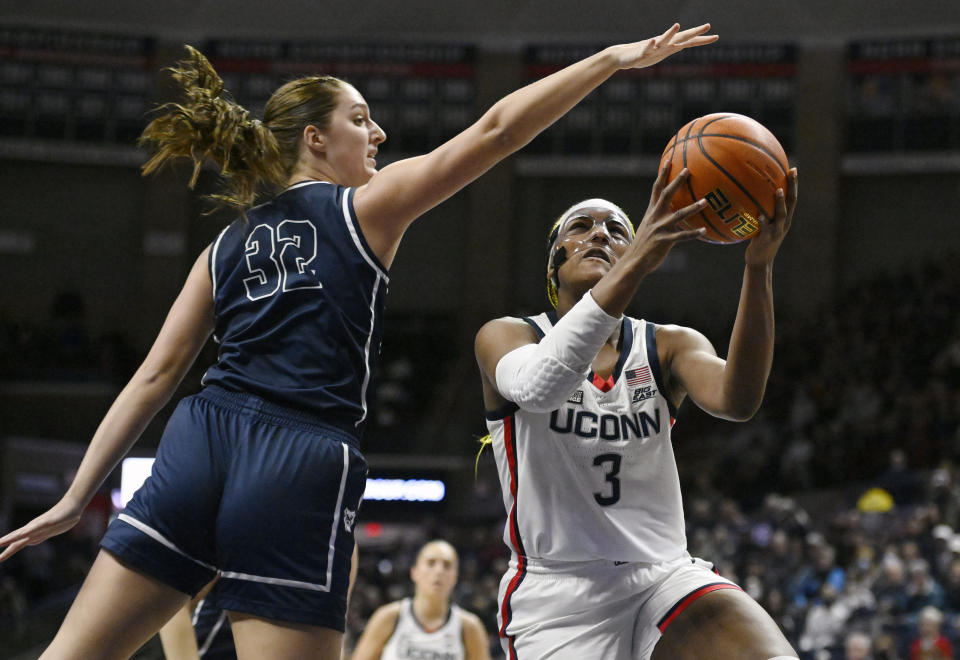 UConn's Aaliyah Edwards (3) shoots over Butler's Sydney Jaynes (32) in the first half of an NCAA college basketball game, Saturday, Jan. 21, 2023, in Storrs, Conn. (AP Photo/Jessica Hill)