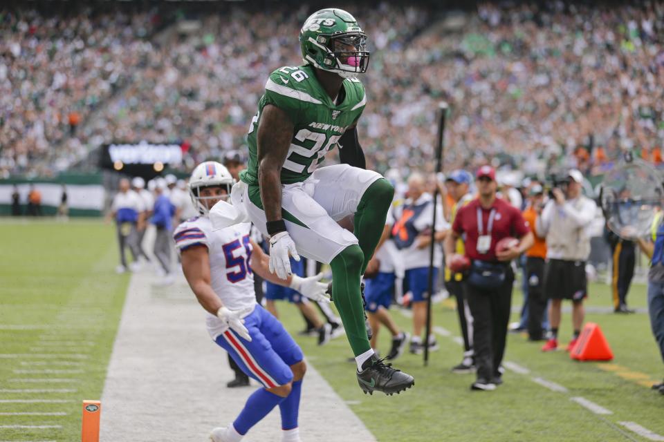 New York Jets running back Le'Veon Bell (26) celebrates after running past Buffalo Bills' Matt Milano (58) for a touchdown during the second half of an NFL football game Sunday, Sept. 8, 2019, in East Rutherford, N.J. (AP Photo/Seth Wenig)