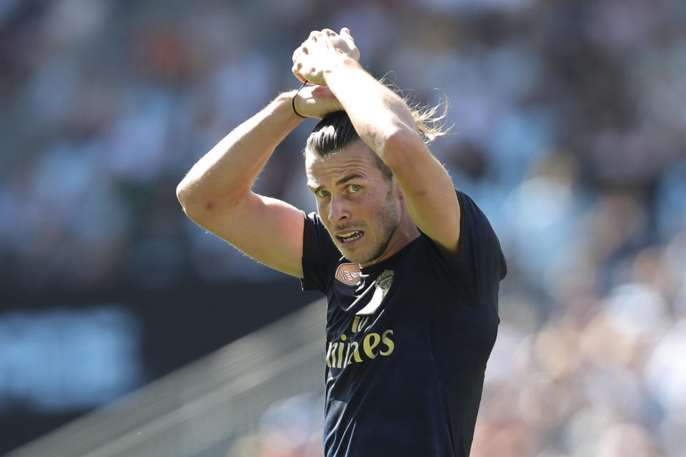 Real Madrid's Gareth Bale fixes his hair during La Liga soccer match between Celta and Real Madrid at the Balaídos Stadium in Vigo, Spain, Saturday, Aug. 17, 2019. (AP Photo/Luis Vieira)