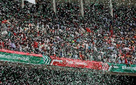 People celebrate as Kenya's President Uhuru Kenyatta takes the oath of office during his swearing-in ceremony - Credit:  BAZ RATNER/ REUTERS