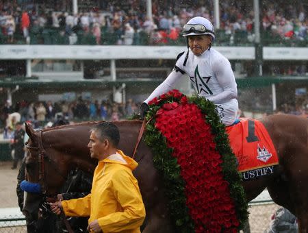 May 5, 2018; Louisville, KY, USA; Mike Smith aboard Justify (7) in the winner's circle after winning the 144th running of the Kentucky Derby at Churchill Downs. Mandatory Credit: Mark Zerof-USA TODAY Sports