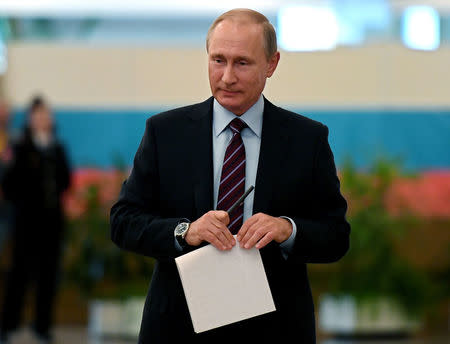 FILE PHOTO: Russian President Vladimir Putin is seen at a polling station during the municipal elections in Moscow, Russia, September 10, 2017. REUTERS/Yuri Kadobnov/Pool