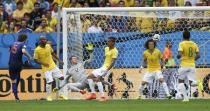 Daley Blind of the Netherlands (L) shoots to score against Brazil during their 2014 World Cup third-place playoff at the Brasilia national stadium in Brasilia July 12, 2014. REUTERS/Ueslei Marcelino