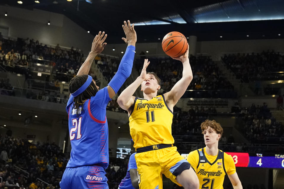 Marquette's Tyler Kolek (11) shoots as DePaul's Da'Sean Nelson defends during the first half of an NCAA college basketball game, Saturday, Jan. 28, 2023, in Chicago. (AP Photo/Charles Rex Arbogast)