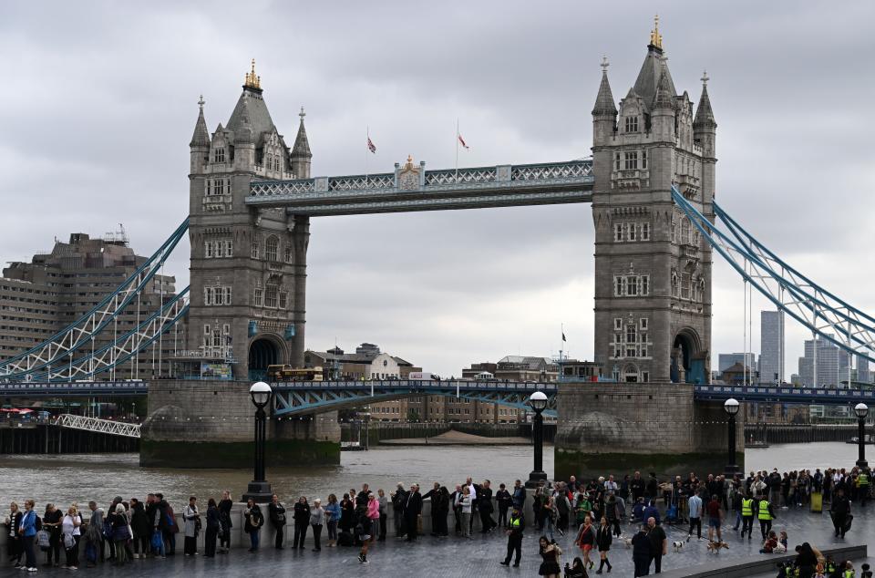 Members of the public stand in the queue on the South Bank of the River Thames, alongside Tower Bridge, as they wait in line to pay their respects to the late Queen Elizabeth II, in London on September 15, 2022.