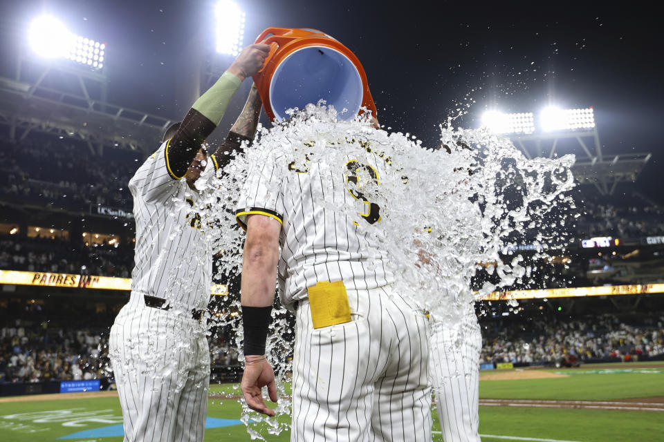 San Diego Padres' Jake Cronenworth, foreground, is doused after his game-winnig solo home run against the Milwaukee Brewers during the ninth inning of a baseball game Thursday, June 20, 2024, in San Diego. (AP Photo/Derrick Tuskan)