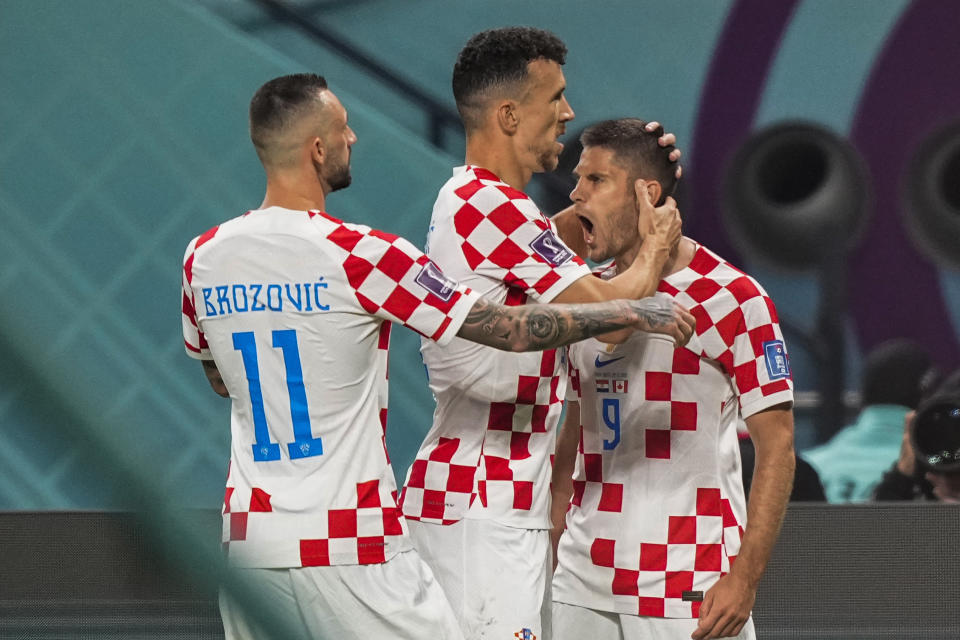 Croatia's Andrej Kramaric, right, jubilates with teammates after scoring his side's first goal during the World Cup group F soccer match between Croatia and Canada, at the Khalifa International Stadium in Doha, Qatar, Sunday, Nov. 27, 2022. (AP Photo/Martin Meissner)