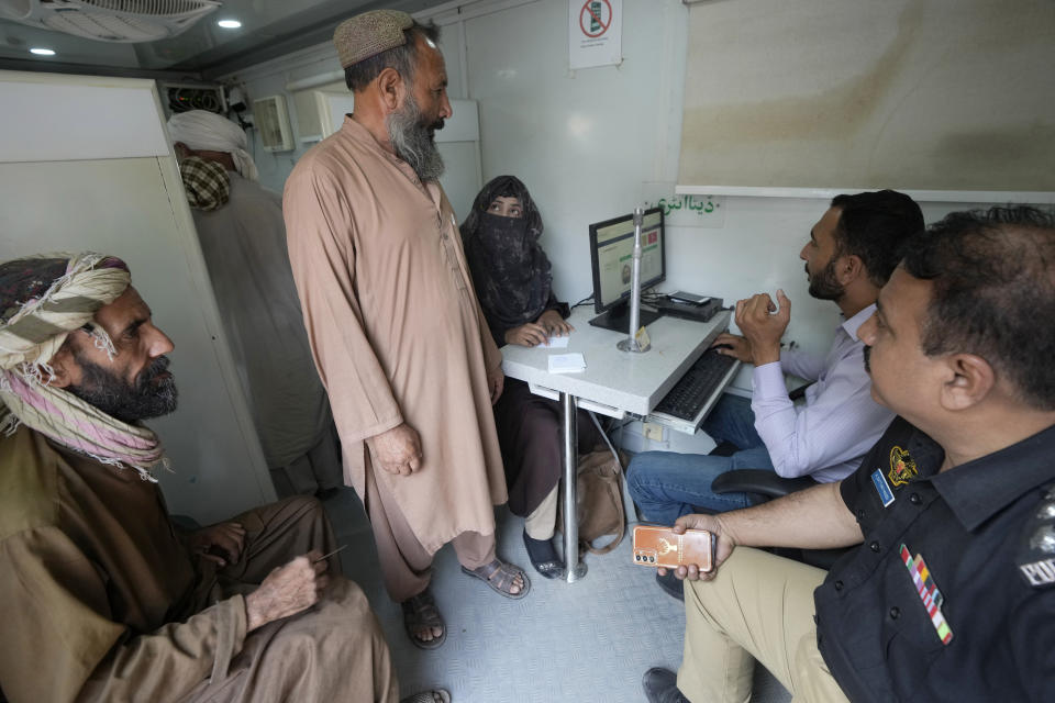 Immigrants go through data verification process at a counter of Pakistan's National Database and Registration Authority, in Karachi, Pakistan, Tuesday, Nov. 7, 2023. Pakistan government launched a crackdown on migrants living in the country illegally as a part of the new measure which mainly target all undocumented or unregistered foreigners. (AP Photo/Fareed Khan)