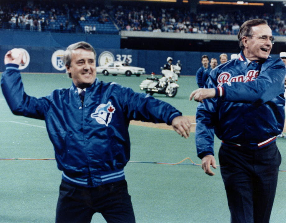 Prime Minister Brian Mulroney and U.S. President George Bush toss out the first pitches at the Toronto Blue Jays home opener against the Texas Rangers at the SkyDome in Toronto on April 10, 1990. Former prime minister Brian Mulroney is dead at 84. His family announced late Thursday that the former Tory leader died peacefully, surrounded by loved ones. THE CANADIAN PRESS/Fred Chartrand