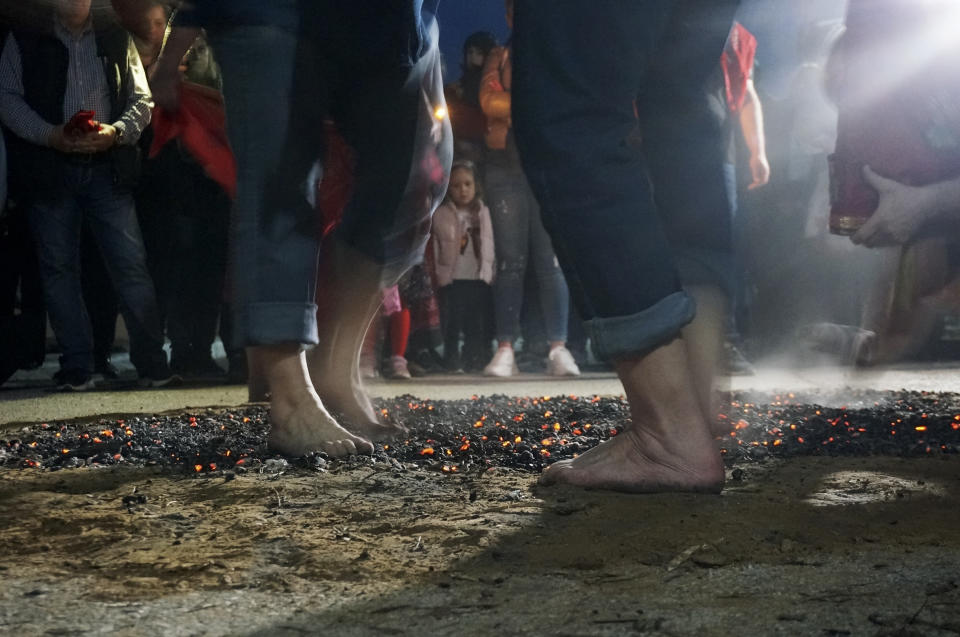 Devotees of St. Constantine called "anastenaria" walk and dance across a bed of burning coals, carrying icons to celebrate the Orthodox saint's feast in Lagkadas, Greece, on Monday, May 22, 2023. "Always there's an amount of fear related to respect," one of them said, but the ritual symbolized empowerment through the saints' intercession to put out the flames. (AP Photo/Giovanna Dell'Orto)